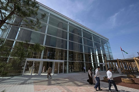 People walk outside the UAE pavilion in the city of Osaka, Japan.