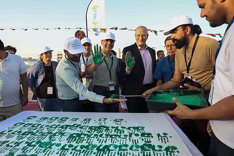 Dr Tariq Fathey from Dubai Health, Dr Faisal Ikram, Zahid Hussain and Abu Bakar Imtaiz from Pakistan Association Dubai giving hand impression as part of the Hands of the Unity initiative at the Health Festival in Dubai on Sunday