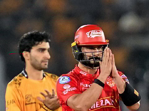 Islamabad United's Sahibzada Farhan (R) celebrates after scoring his century in the Pakistan Super League Twenty20 match against Peshawar Zalmi in Rawalpindi on Monday.