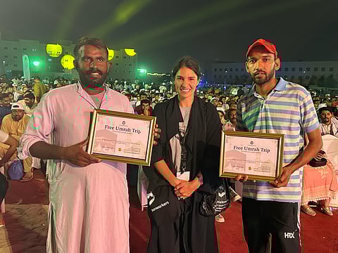 Sophia Sarah Addas presents two free Umrah trips to blue-collar workers during an event in Dubai.