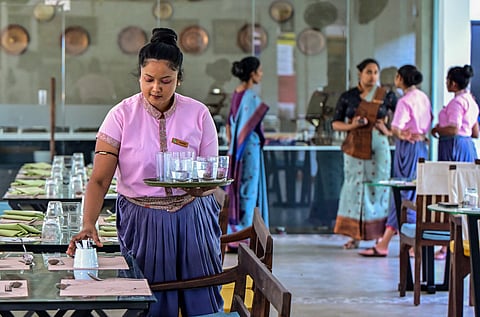 A housekeeping staff setting a dining table at the Hotel Amba Yaalu in Kandalama, in central Sri Lanka.