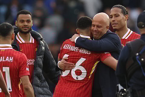 Liverpool's Dutch manager Arne Slot embraces goal-scorer Trent Alexander-Arnold on the pitch after the English Premier League match against Leicester City  on Sunday.