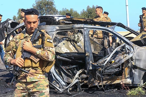 Lebanese soldiers inspect the site near a burnt-out vehicle reportedly hit by an Israeli strike in Ghazieh, near Sidon, on April 18, 2025. Lebanon