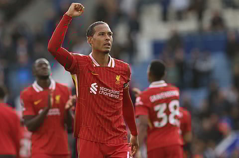 Liverpool's Dutch defender Virgil van Dijk celebrates on the pitch after the English Premier League football match against Leicester City at King Power Stadium in Leicester, central England on April 20.