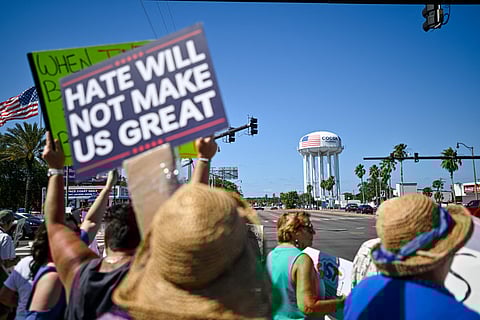 Demonstrators rally against Trump and join forces during a protest organized by the 50501 Movement on April 19, 2025, in Cocoa, Florida.