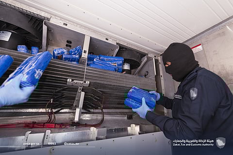 A Saudi customs officer displays cocaine recently seized at the Jeddah port.