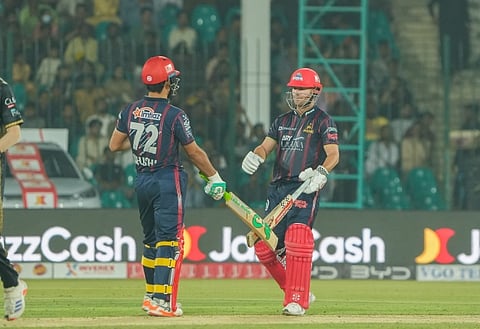 David Warner (right) and Khushdil Shah played crucial roles in Karachi Kings winning their PSL match against Peshawar Zalmi on Monday.