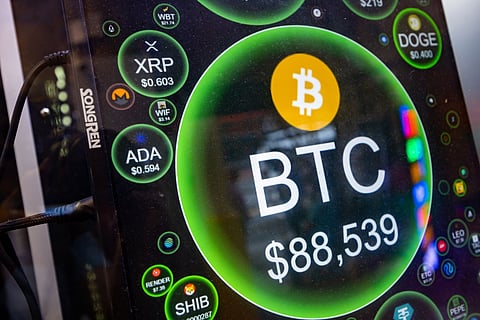 A screen shows the price of Bitcoin against the US dollar