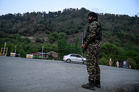 An Indian paramilitary personnel stands guard near Pahalgam, south of Srinagar, on April 22, 2025, following an attack.