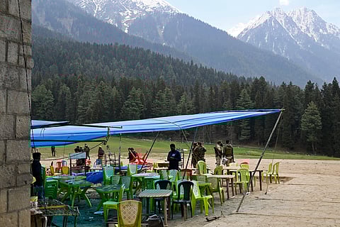 Security personnel inspect the site in the aftermath of an attack as food stall chairs lie empty in Pahalgam, about 90 kilometres (55 miles) from Srinagar on April 23, 2025.