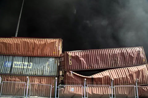 Black smoke rises behind damaged containers following an explosion at the Shahid Rajaee port dock southwest of Bandar Abbas in the Iranian province of Hormozgan on April 26, 2025.
