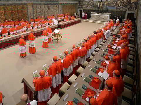 This handout picture released by the Press office shows cardinals queuing in the Sistine Chapel to swear on the Bible to never reveal the secrets of their deliberations before the start of the conclave at the Vatican on March 12, 2013