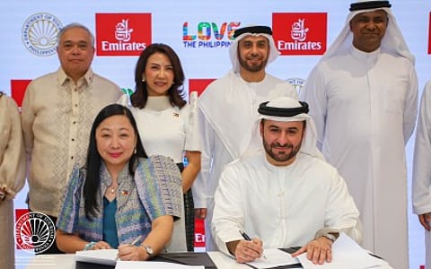 TOURISM DEAL SEALED: Undersecretary Verna Buensuceso (left), of the Philippine Department of Tourism, and Emirates Airlines Senior VP Orhan Abbas (right) sign a pact on Monday (April 28, 2025) to boost the Philippines’ tourism reach in the Middle East and Europe.