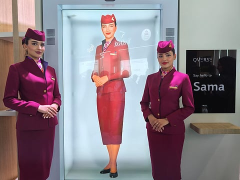 Human cabin crew alongside Qatar Airways’ AI-powered digital cabin crew, Sama.