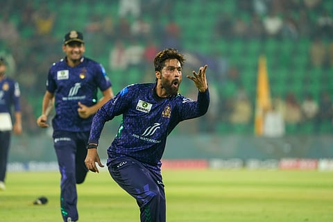 Mohammad Amir celebrates after dismissing Babar Azam during their PSL match on Sunday.