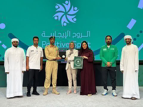 Yongmei Li, a Chinese expat woman receiving special recognition award from Dubai Police officials.