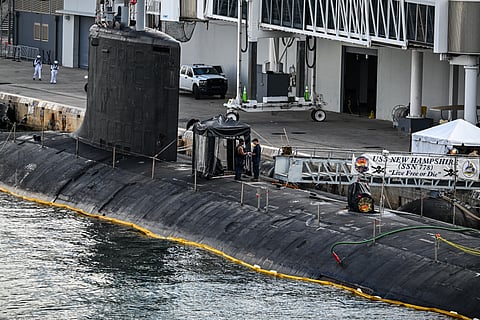 US Navy personnel stand a top USS New Hampshire (SSN-778), a Virginia-class nuclear-powered attack submarine at Port Everglades in Fort Lauderdale, Florida, on April 29, 2025.
