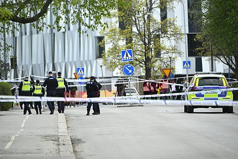 Police officers cordon off the scene after several people were killed in a shooting at Vaksala Square in central Uppsala, Sweden on April 29, 2025.