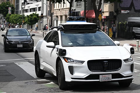 A Waymo autonomous self-driving Jaguar electric vehicle drives in downtown Los Angeles, California on May 1, 2025.