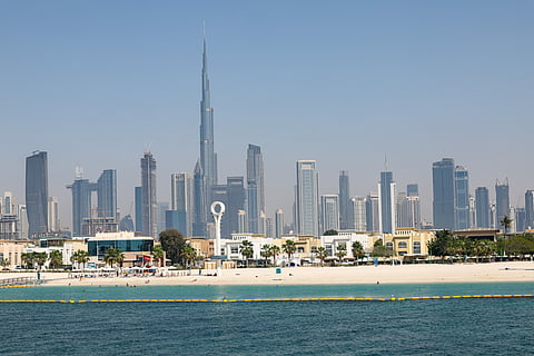 Beach with Dubai skyline.