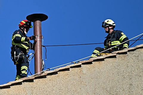 Workers install the chimney on the roof of the Sistine Chapel in The Vatican, on May 2, 2025.