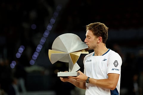 Norway's Casper Ruud kisses his trophy on the podium after winning Britain's Jack Draper during their 2025 ATP Tour Madrid Open tennis tournament singles final match at the Caja Magica in Madrid, on May 4.