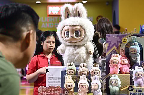 People look at collectable designer art toy Labubu at a Pop Mart pop-up store in Siam Center shopping mall in Bangkok on May 6, 2025.