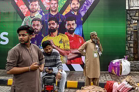 Vendors pack their belongings as they leave Rawalpindi Cricket Stadium following the postponement of the Pakistan Super League (PSL) match after the alleged shooting of a drone outside the stadium in Rawalpindi on May 8, 2025.