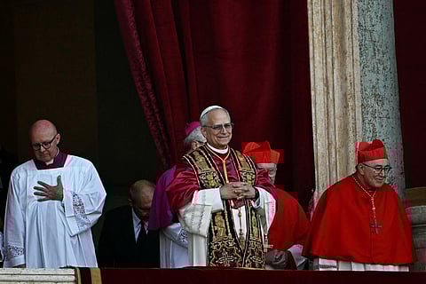 Newly elected Pope Leo XIV, Robert Francis Prevost (C) arrives on the main central loggia balcony of the St Peter's Basilica, after the cardinals ended the conclave, in The Vatican, on May 8, 2025.