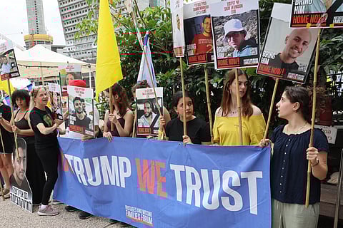 People hold placards with images of hostages held in Gaza since October 2023 on the day US special envoy to the Middle East, Steve Witkof, is expected to visit the Hostages Square in Tel Aviv, on May 13, 2025, less than 24 hours since Edan Alexander, a US-Israeli soldier freed by Palestinian militant group Hamas after 584 days in captivity was reunited with his family in Israel.