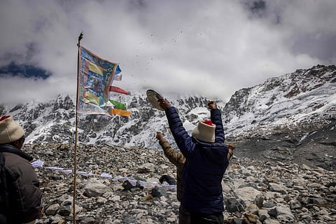 Buddhist monks performed rituals as prayer flags fluttered against the Himalayan backdrop.