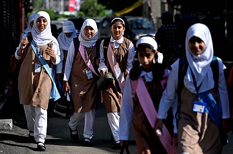 Students walk to attend classes as their school reopened after a ceasefire between Pakistan and India.