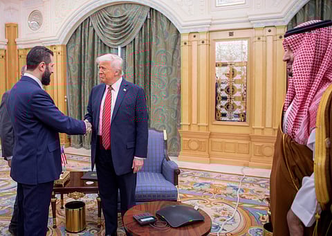Saudi Crown Prince Mohammed bin Salman (right) watches as US President Donald Trump shakes hands with Syrian leader Ahmed Al Sharaa on May 14, 2025.