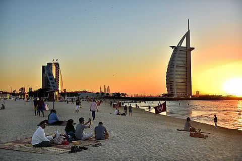 Residents enjoy the sun and sea on Jumeirah Public Beach, with the towering silhouette of the Burj Al Arab rising in the background. The beach, a popular spot for locals and visitors alike, offers a unique contrast between everyday coastal life and one of Dubai’s most iconic symbols of luxury and ambition.