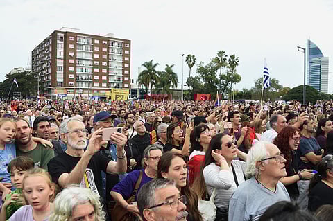 Supporters of Uruguay's former President Jose 'Pepe' Mujica bid farewell while the casket with his remains leaves the Palacio Legislativo in Montevideo on May 15, 2025.