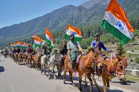 Hoteliers, pony riders and tour guides carrying Indian national flags shout pro India slogans during a Tiranga Yatra or tricolor march to highlight the success of Indian military Operation Sindoor, in Pahalgam in Indian administered Kashmir on May 15, 2025.