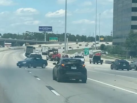 The car was towed backward at high speed on the highway, zigzagging wildly with a panicked driver inside