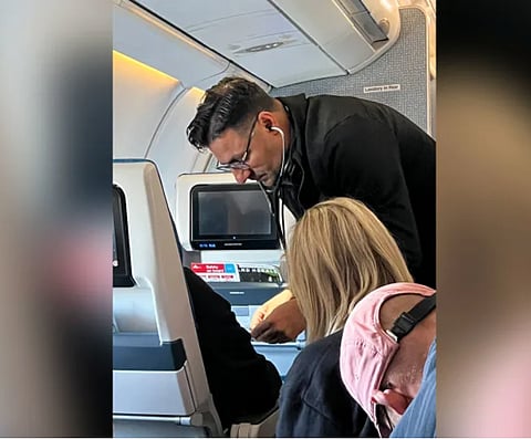 Cardiologist Dr. TJ Trad calmly helps a fellow passenger who had a suspected heart attack on a KLM flight.
