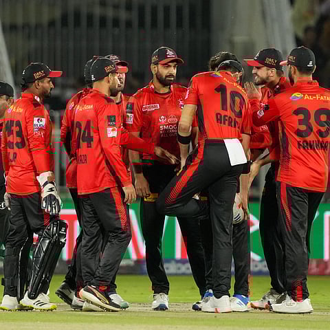 Lahore Qalandars celebrate a wicket during their Pakistan Super League match against Peshawar Zalmi on Sunday.