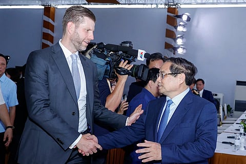 Eric Trump (L), son of US President Donald Trump, shakes hands with Vietnam's Prime Minister Pham Minh Chinh (R) during the groundbreaking ceremony for the Trump International, Hung Yen resort and golf course project in Hung Yen province on May 21, 2025.