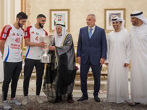 Dr Sheikh Sultan receives the AFC Champions League 2 Cup during the reception to honour the victories Sharjah Football Club on Tuesday.