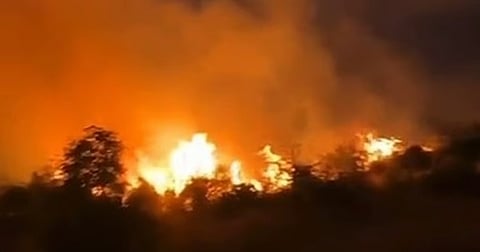 Flames and smoke from a wildfire billow in the Saudi governorate of Al Mandaq.