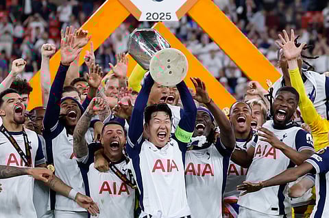 Tottenham Hotspur's Son Heung-min raises the trophy as he celebrates with teammates after winning the Uefa Europa League final in Bilbao on Wednesday.