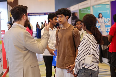 Students interacting with exhibitors on courses and universities at Gulf News Edufair in Dubai