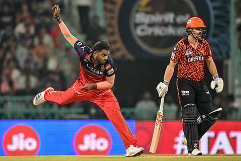 Royal Challengers Bengaluru's Yash Dayal (L) bowls as Sunrisers Hyderabad's Travis Head watches during the Indian Premier League (IPL) Twenty20 cricket match at the Ekana Cricket Stadium in Lucknow on May 23, 2025.