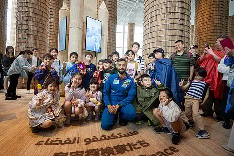 Dr Sultan Al Neyadi with Japanese children at Expo 2025 Osaka.