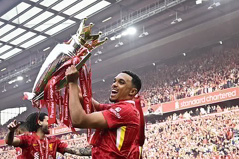 Liverpool's Trent Alexander-Arnold celebrates with the Premier League trophy. The English defender has joined Real Madrid in time for Club World Cup.