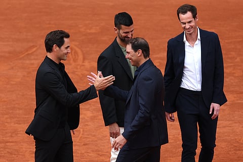 Former Swiss tennis player Roger Federer (L) shakes hands with former Spanish tennis player Rafael Nadal, next to Serbia's Novak Djokovic (C) and Britain's tennis coach Andy Murray (R) during a ceremony honoring Rafael Nadal's career on Court Philippe-Chatrier as part of the French Open tennis tournament at the Roland-Garros Complex in Paris on May 25, 2025.