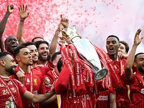 Liverpool players celebrate with the Premier League trophy at Anfield on Sunday.