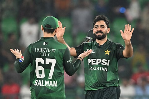 Pakistan's Khushdil Shah (R) celebrates with Salman Ali Agha (L) after taking the wicket of Bangladesh's Towhid Hridoy (not pictured) during the first Twenty20 international cricket match between Pakistan and Bangladesh at the Gaddafi Cricket Stadium in Lahore on May 28, 2025.